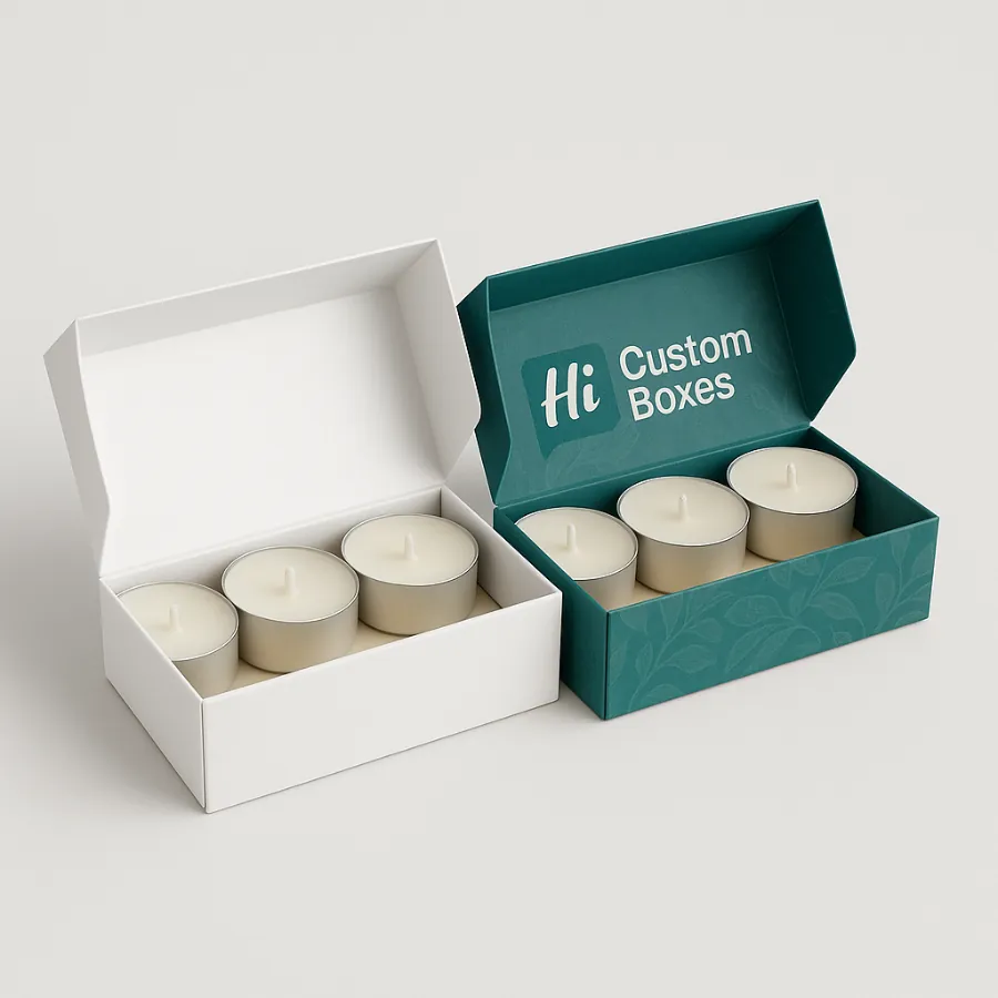 Two open- large square boxes- one white- one teal- containing twenty white tealight candles- class=